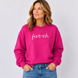 Woman wearing a bright pink sweatshirt with 'five-oh' text on a plain background