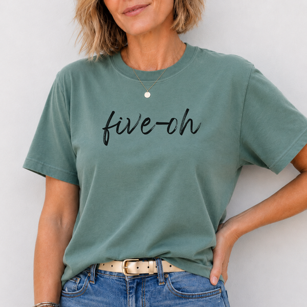 Person wearing a green t-shirt with 'five-oh' text against a white background