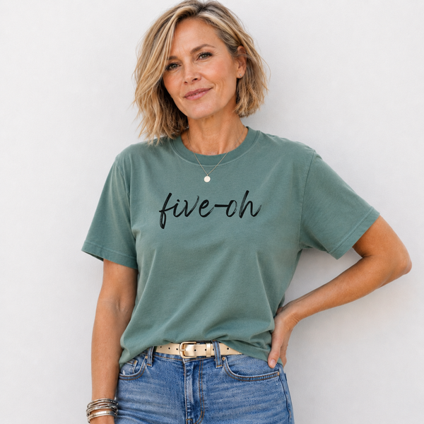 Woman wearing a green t-shirt with 'five-oh' text against a white background