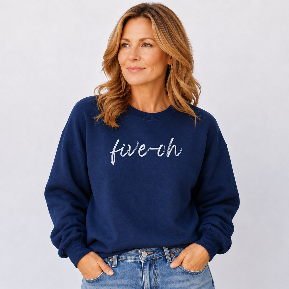 Woman wearing a navy blue sweatshirt with 'five-oh' text on a plain background
