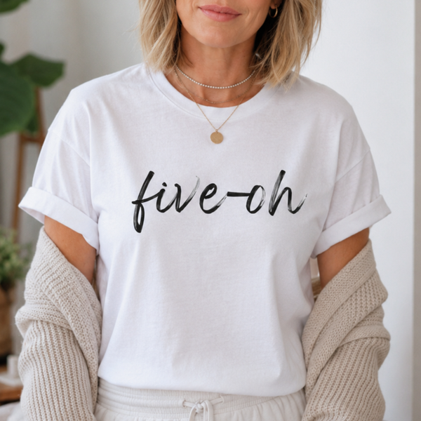 Person wearing a white t-shirt with 'five-oh' text, standing indoors.