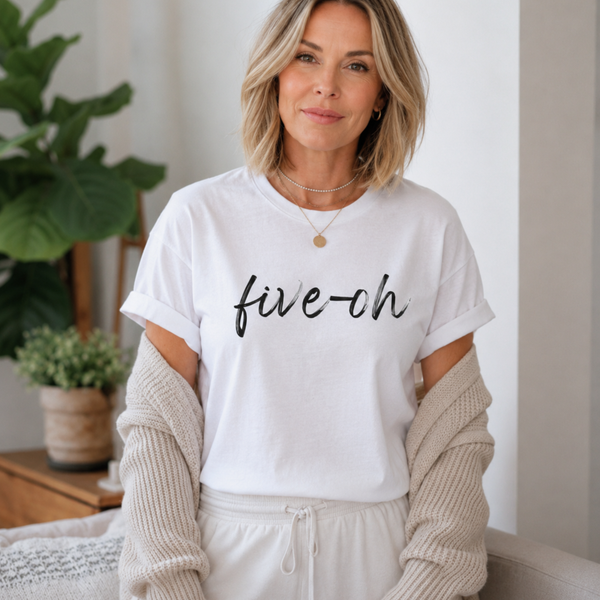 Woman wearing a white t-shirt with 'five-oh' text in a home setting