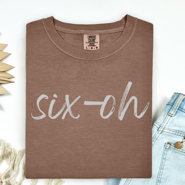 Brown t-shirt with 'six-oh' text on a white background
