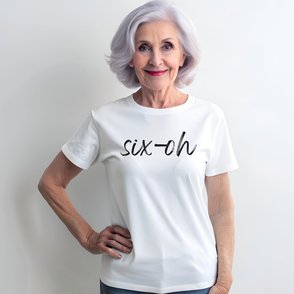 Woman wearing a white t-shirt with 'six-oh' text against a plain background