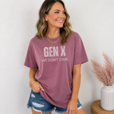 A woman standing  in a berry colored tee shirt on that says 