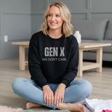 Woman wearing a black sweatshirt with 'GEN X WE DON'T CARE' text, sitting in a modern living room.