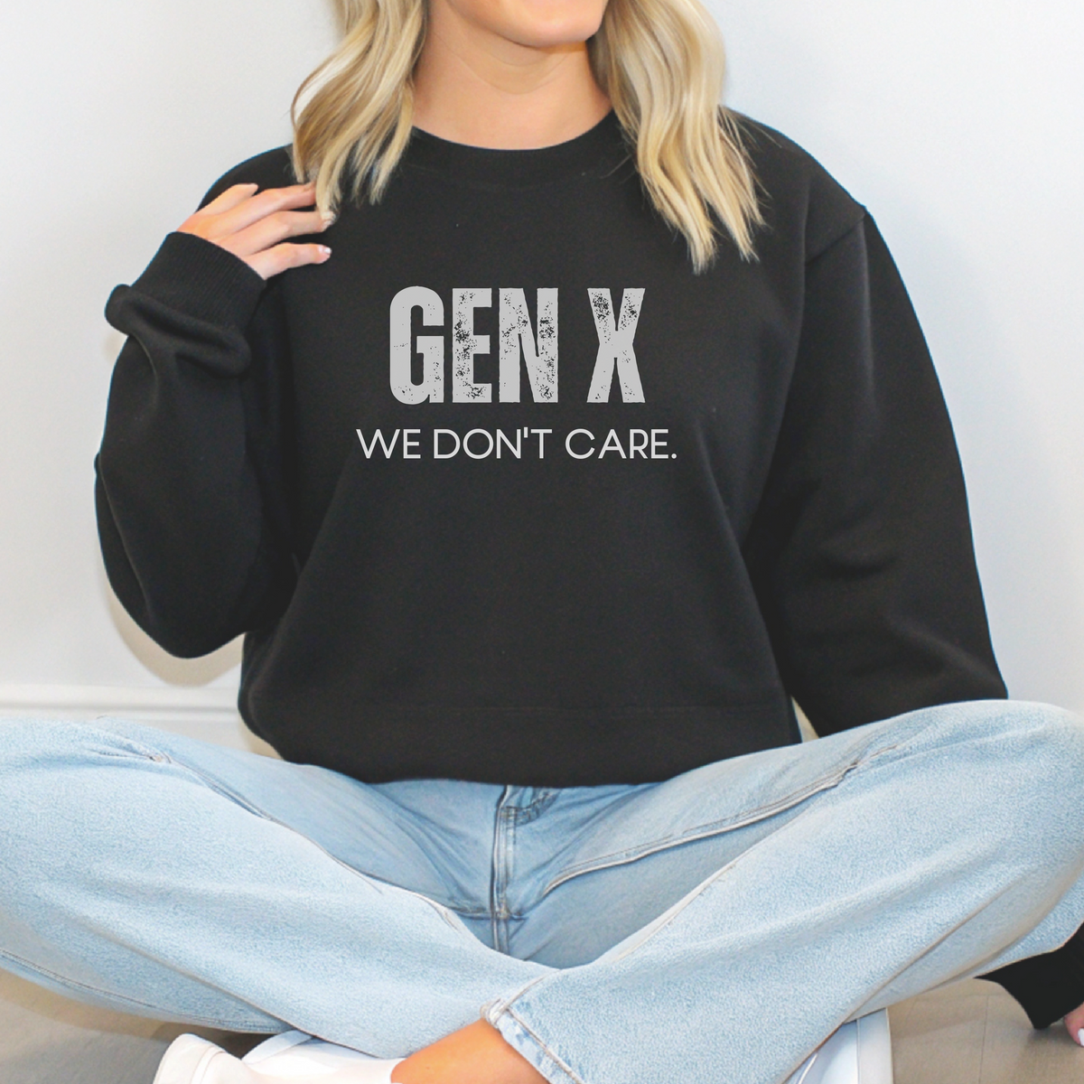 Person wearing a black sweatshirt with 'GEN X WE DON'T CARE' text.