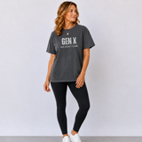 A woman standing in a pepper black tee shirt on that says 