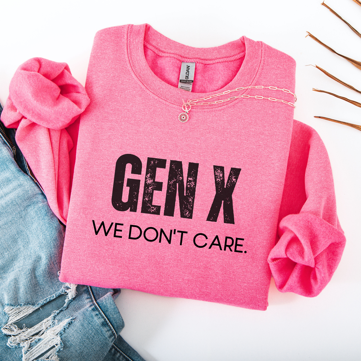 Pink sweatshirt with 'GEN X WE DON'T CARE' text on a white background