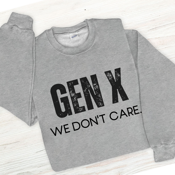 Gray sweatshirt with 'GEN X WE DON'T CARE' text on a light wooden surface