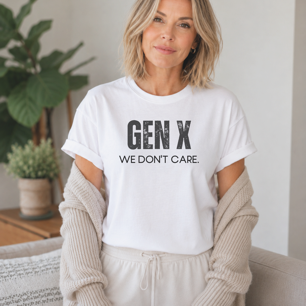 A woman standing in a white tee shirt on that says "Gen X: We Don't Care."