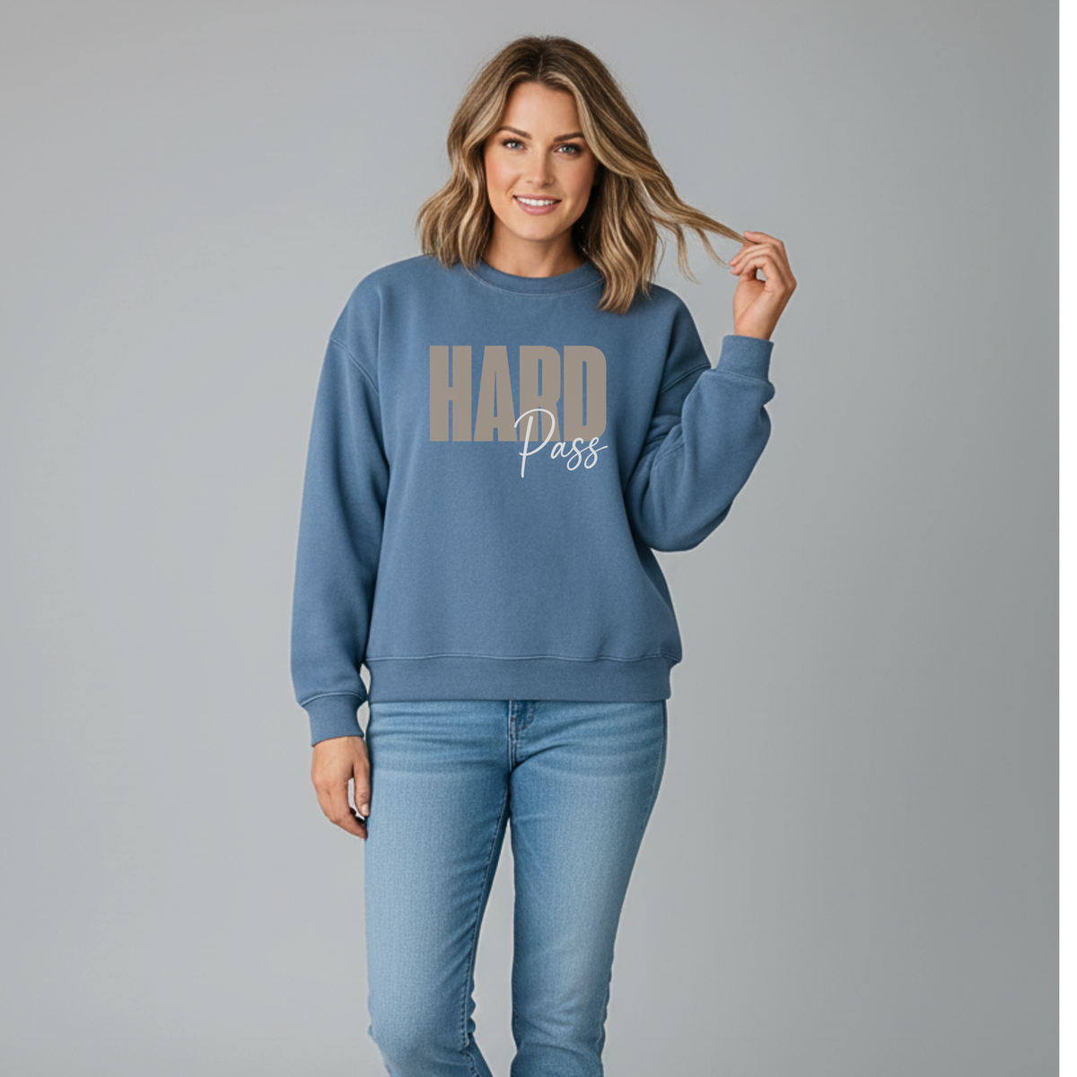 Woman wearing a blue sweatshirt with 'HARD Pass' text on a gray background