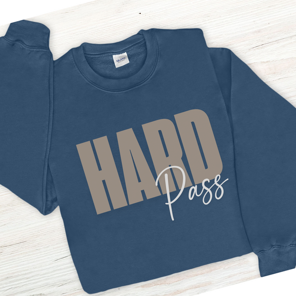 Blue sweatshirt with 'HARD Pass' text on a wooden surface