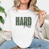 Person wearing a white t-shirt with 'HARD Pass' text, sitting on a couch.