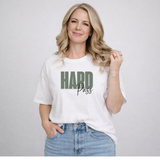 Woman standing in jeans and a white T-shirt that says 