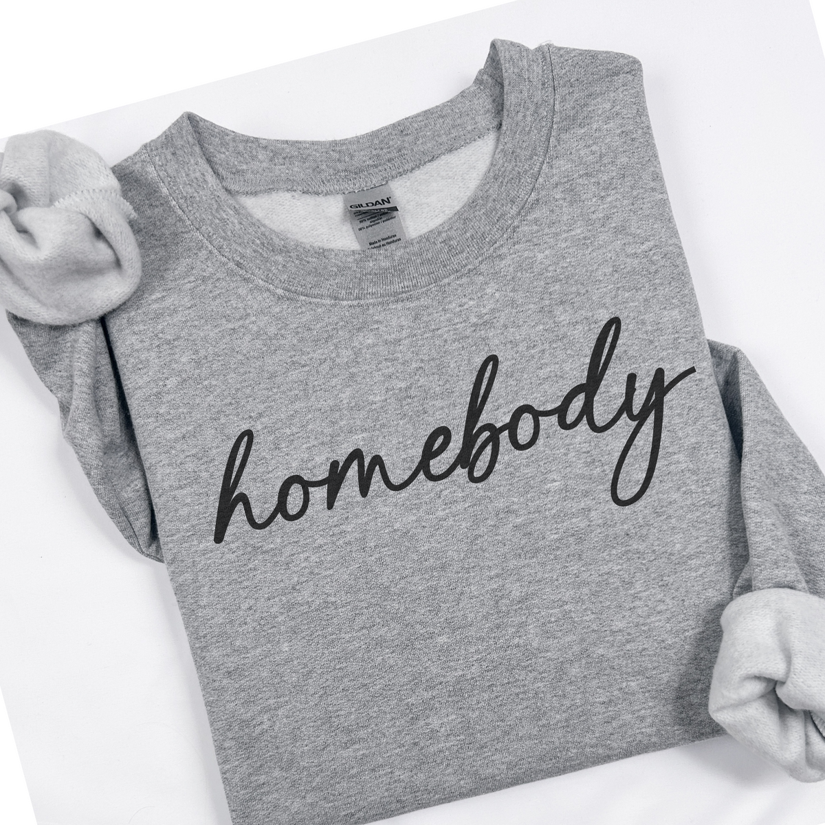 Gray sweatshirt with 'homebody' text on a white background