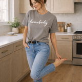 Woman wearing a 'homebody' t-shirt in a kitchen