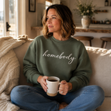 A woman in a dark green sweatshirt that says 
