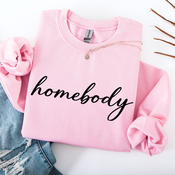 Pink sweatshirt with 'homebody' text on a white background