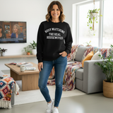 Woman standing  in jeans and sneakers wearing a black sweatshirt with 