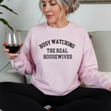 Woman wearing a pink sweatshirt with 