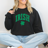 Person wearing a black sweatshirt with 'IRISH' and a clover design.