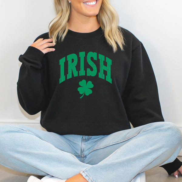 Person wearing a black sweatshirt with 'IRISH' and a clover design.