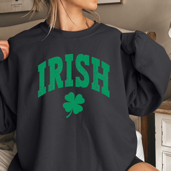 Person wearing a black sweatshirt with 'IRISH' and a clover design.