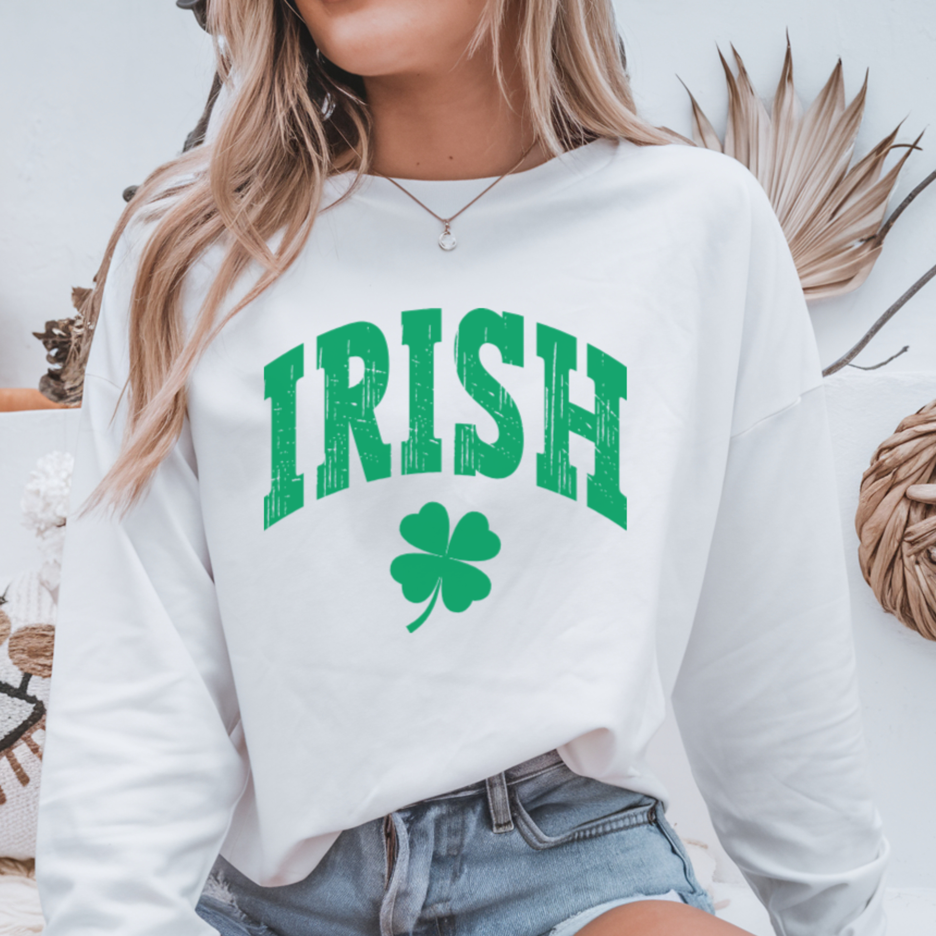 Person wearing a white sweatshirt with 'IRISH' and a clover graphic.