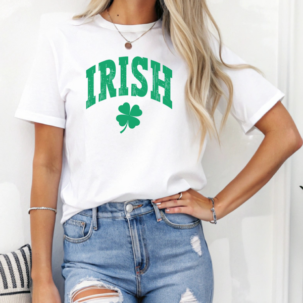 Person wearing a white t-shirt with 'IRISH' and a shamrock design on a plain background