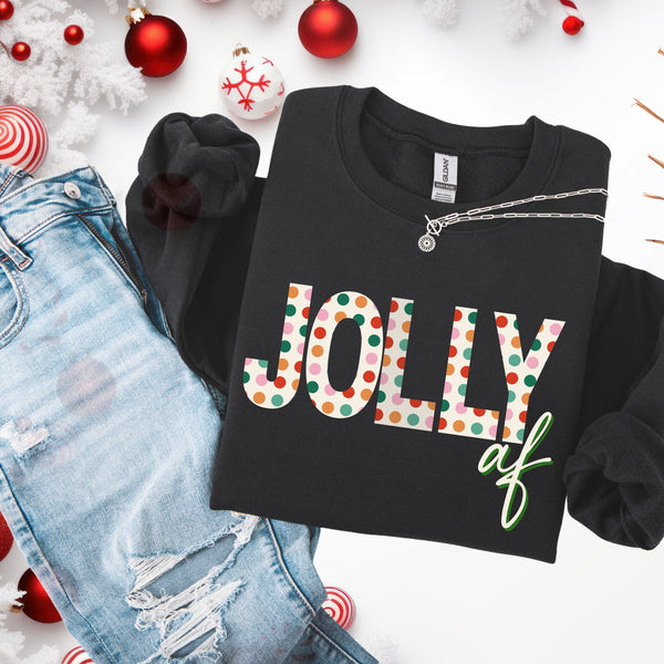 Black sweatshirt with 'Jolly af' text on a white background with Christmas decorations.