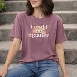 Woman wearing a berry pink purple t-shirt with a rainbow and text design, that says 