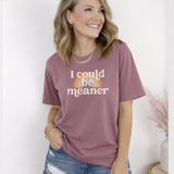 Woman wearing a berry pink purple t-shirt with a rainbow and text design, that says 
