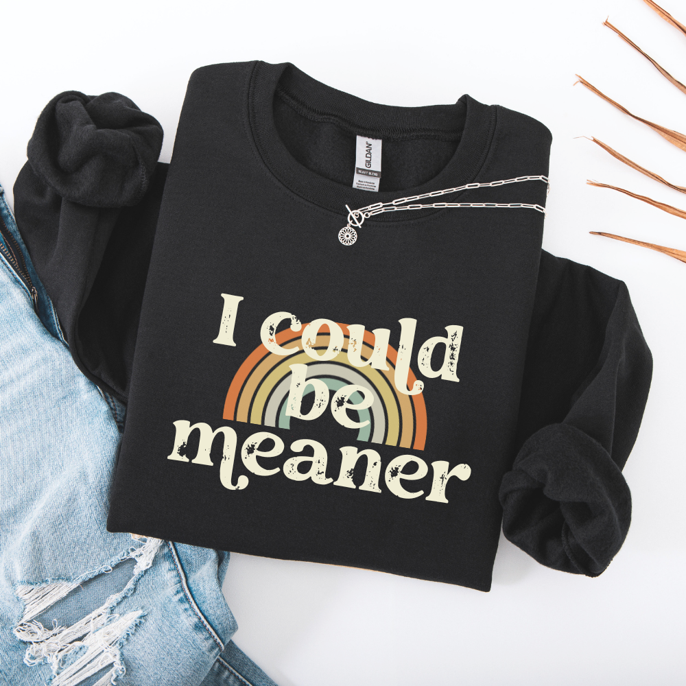 Foldend Black sweatshirt with 'I could be meaner' text and rainbow design on a white background