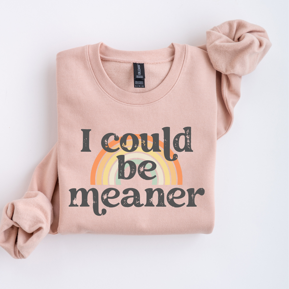Folded dusty pink sweatshirt with rainbow and text on a white background