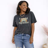 Woman wearing a dark gray t-shirt with a colorful graphic and text that says 