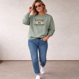 Woman wearing a green sweatshirt with 'i could be meaner' text over a rainbow and blue jeans walking outside