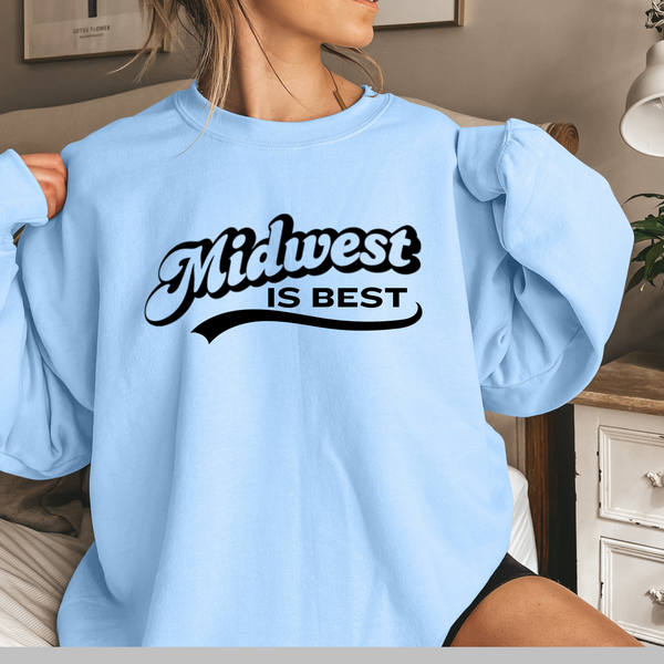 Light blue sweatshirt with 'Midwest is Best' text worn by a person indoors.