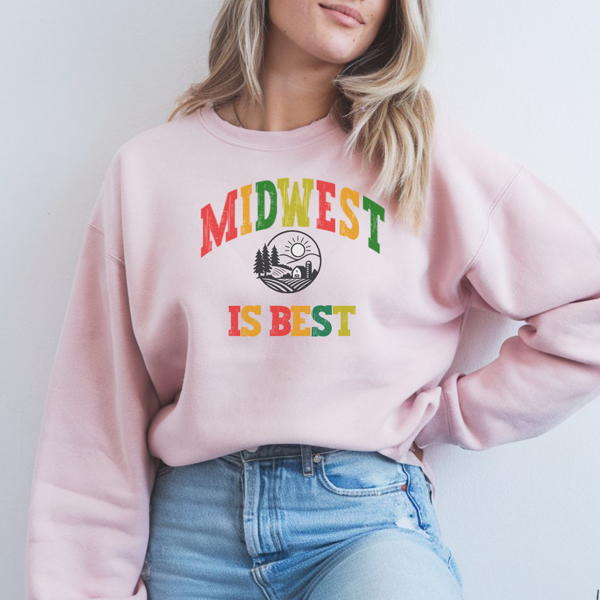 Person wearing a pink sweatshirt with 'Midwest is Best' text and design.