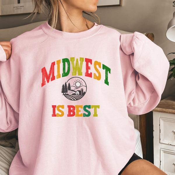 Person wearing a pink sweatshirt with 'Midwest is Best' text in colorful letters.