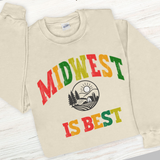 Beige sweatshirt with 'Midwest is Best' text and graphic on a wooden surface