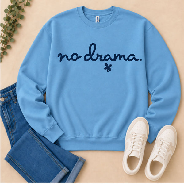 A blue sweatshirt with the words "no drama" written on it with jeans and sneakers