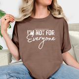 Person wearing a brown t-shirt with 'I'm Not For Everyone' text.