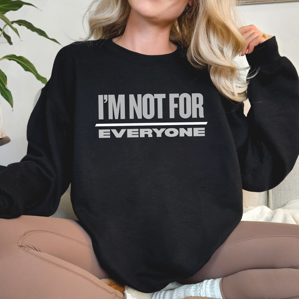 Person wearing a black sweatshirt with 'I'M NOT FOR EVERYONE' text.
