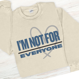 Beige sweatshirt with 'I'm not for everyone' text on a wooden surface