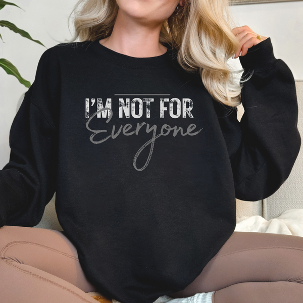 Person wearing a black sweatshirt with 'I'm not for everyone' text.