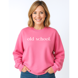 A 50 year old Woman wearing a pink sweatshirt with 'old school.' text in white on a white background