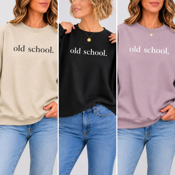 Three models in three sweatshirts that all say "old school" The sweatshirts are beige, black and light purple.