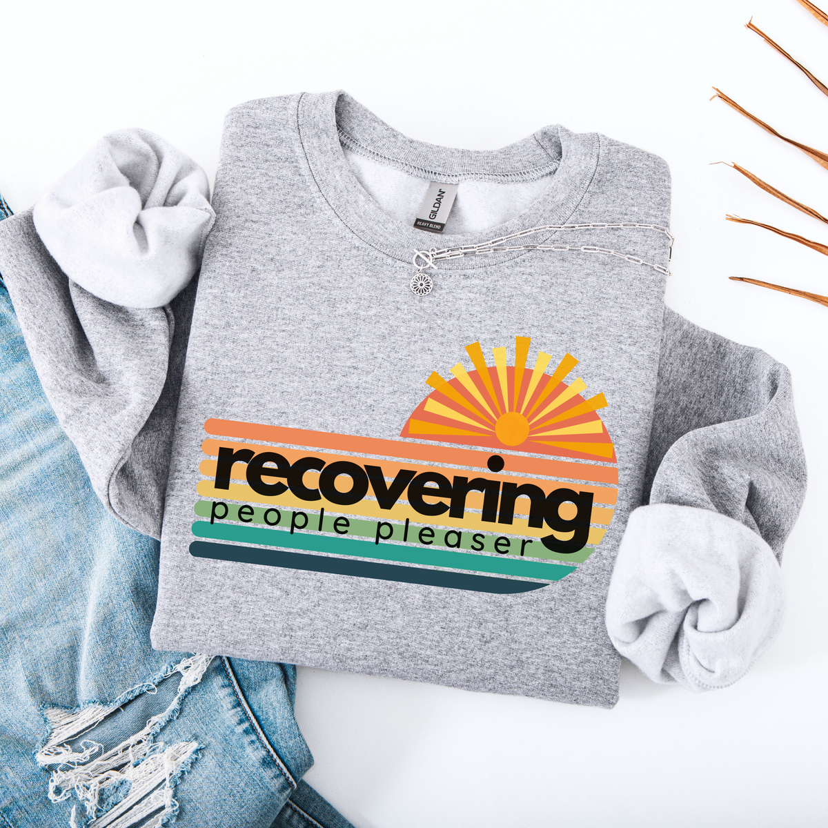 Gray sweatshirt with a colorful graphic and text on a white background