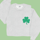 Gray sweatshirt with a green shamrock on a green background